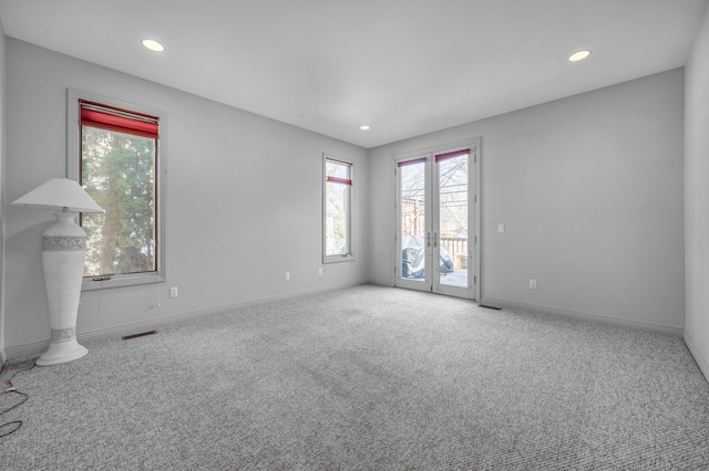 spare room featuring visible vents, recessed lighting, french doors, carpet flooring, and baseboards