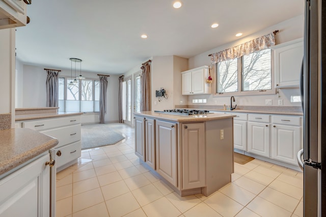 kitchen with light tile patterned floors, white cabinets, and appliances with stainless steel finishes