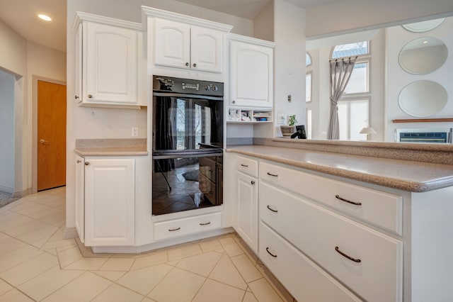 kitchen featuring a peninsula, recessed lighting, light countertops, white cabinets, and dobule oven black