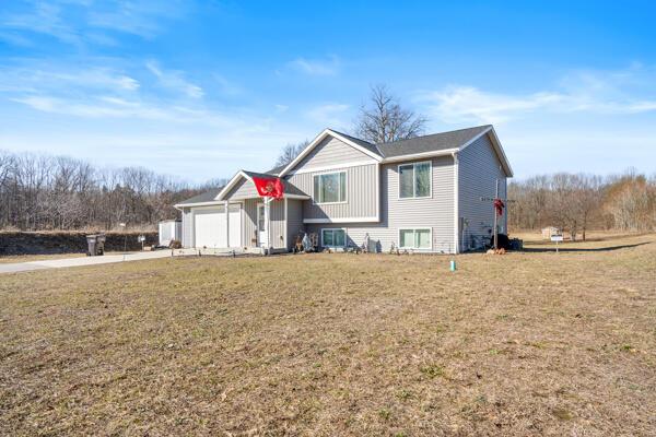 view of front of property with a garage and a front lawn