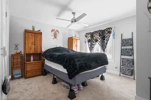 bedroom with baseboards, light carpet, and ceiling fan