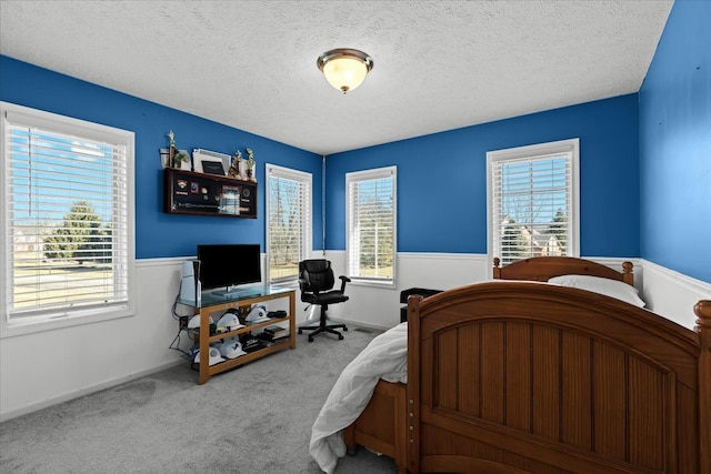 carpeted bedroom featuring a textured ceiling