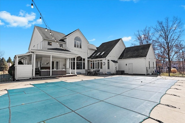 back of house featuring a fenced in pool, fence, cooling unit, a sunroom, and a patio