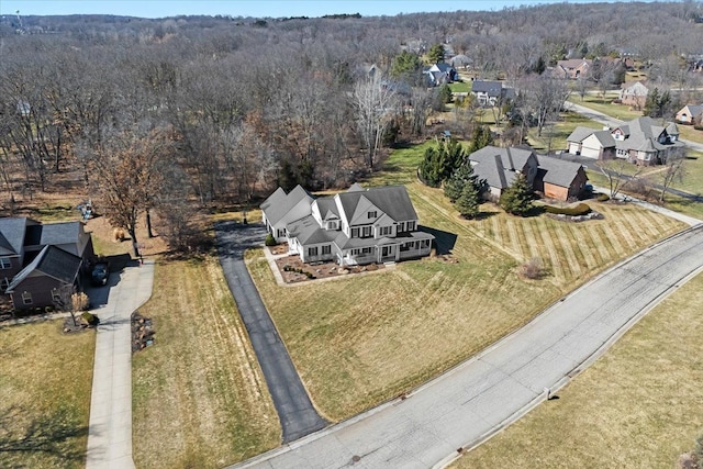 birds eye view of property featuring a view of trees and a residential view