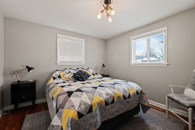 bedroom with baseboards and wood finished floors