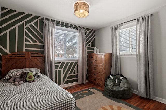 bedroom featuring baseboards and wood finished floors