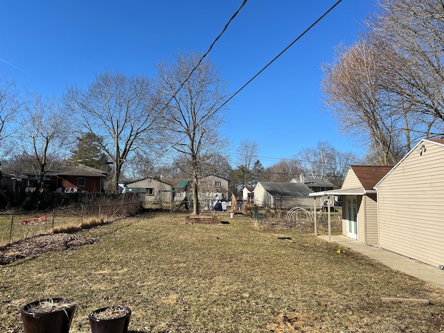 view of yard with a residential view and fence