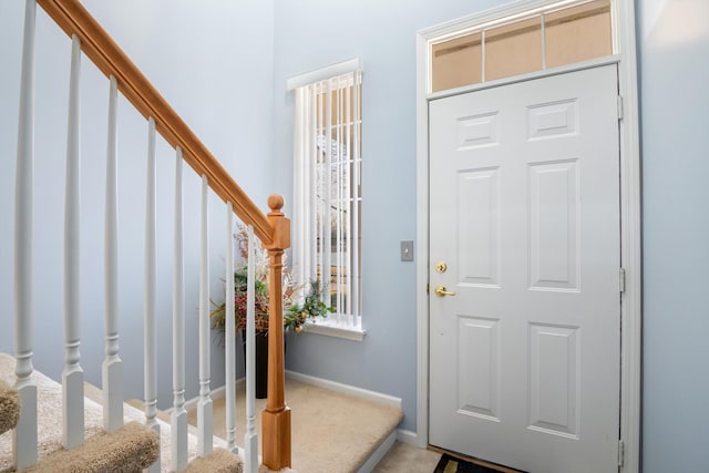 entryway featuring stairs and baseboards