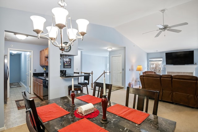 dining space featuring ceiling fan with notable chandelier and lofted ceiling