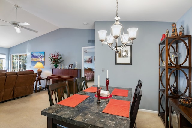 dining room with visible vents, light colored carpet, vaulted ceiling, and ceiling fan with notable chandelier