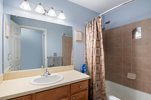 bathroom featuring shower / bath combo with shower curtain and vanity