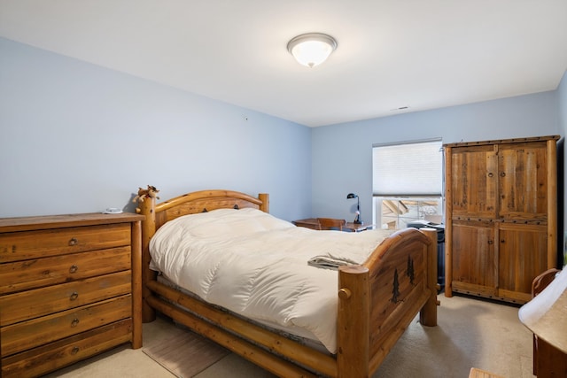 bedroom with light colored carpet