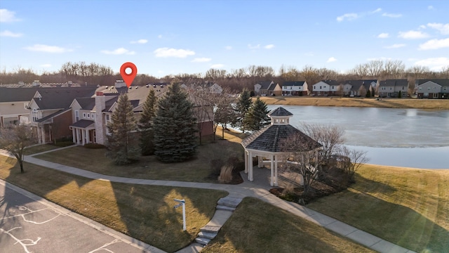 birds eye view of property with a residential view and a water view