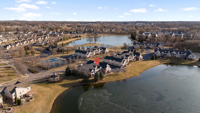 drone / aerial view with a residential view and a water view