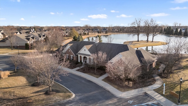 birds eye view of property with a residential view and a water view