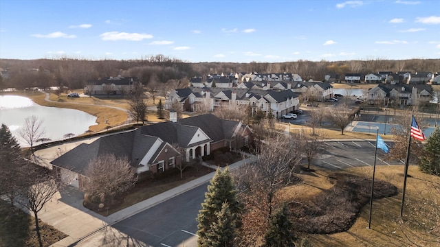 drone / aerial view with a residential view and a water view