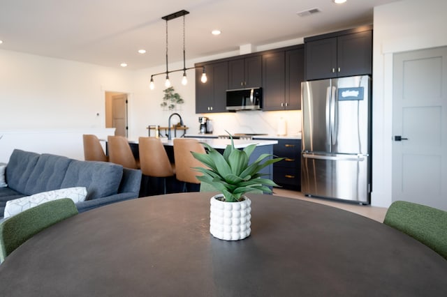 dining space featuring recessed lighting and visible vents