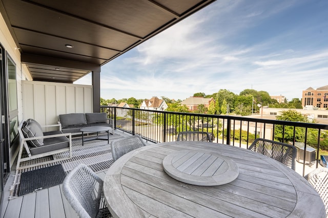 wooden terrace with outdoor lounge area and outdoor dining area