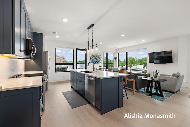 300 Washington Ave Unit 1, Grand Haven, MI 49417 - kitchen with stainless steel dishwasher, light wood-style flooring, open floor plan, healthy amount of natural light, and recessed lighting