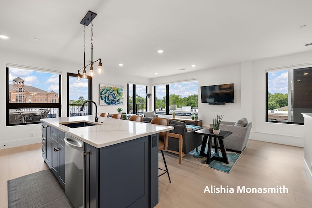 300 Washington Ave Unit 1, Grand Haven, MI 49417 - kitchen featuring light wood-style flooring, stainless steel dishwasher, plenty of natural light, open floor plan, and recessed lighting