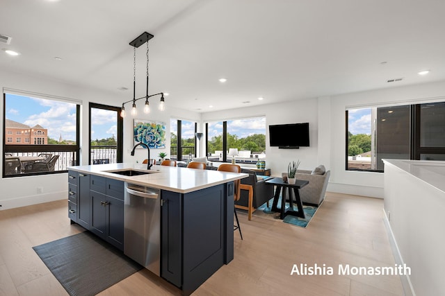 300 Washington Ave Unit 1, Grand Haven, MI 49417 - kitchen featuring stainless steel dishwasher, light wood finished floors, light countertops, open floor plan, and recessed lighting