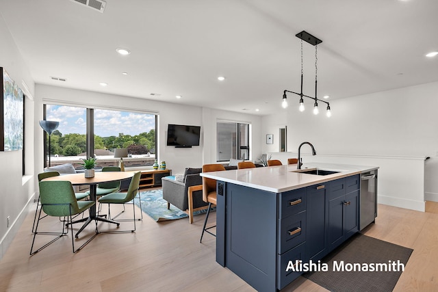 300 Washington Ave Unit 1, Grand Haven, MI 49417 - kitchen featuring light wood-type flooring, light countertops, a breakfast bar, open floor plan, and recessed lighting