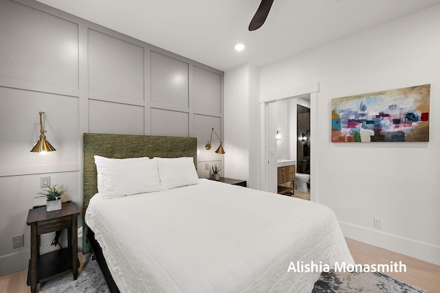 300 Washington Ave Unit 1, Grand Haven, MI 49417 - bedroom with wood finished floors, ensuite bath, and a ceiling fan
