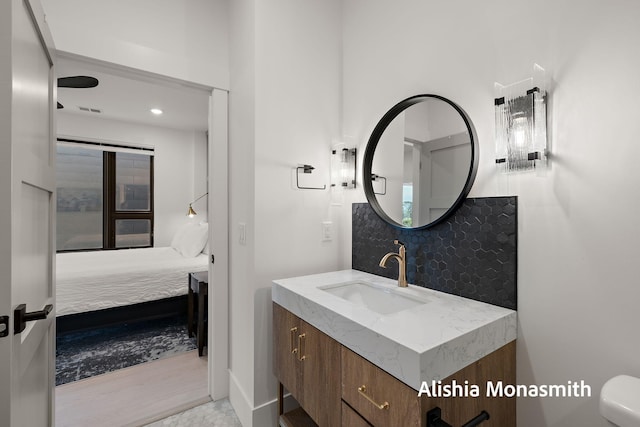 300 Washington Ave Unit 1, Grand Haven, MI 49417 - bathroom featuring vanity, ensuite bathroom, backsplash, and recessed lighting