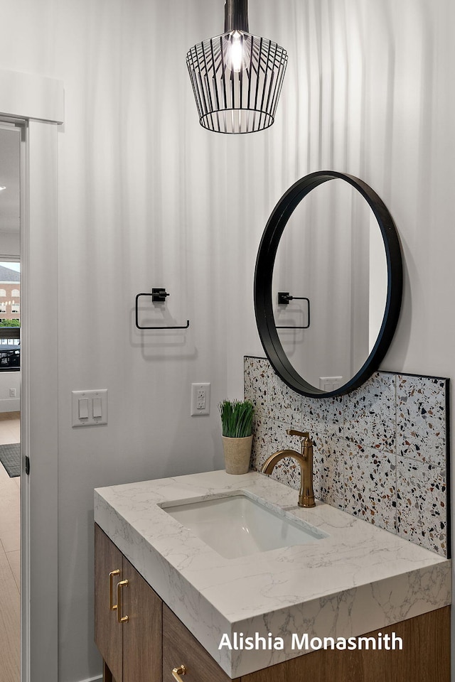 300 Washington Ave Unit 1, Grand Haven, MI 49417 - bathroom featuring vanity and tasteful backsplash