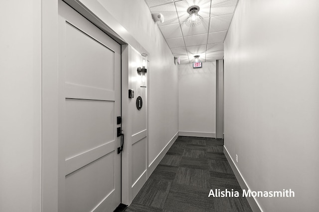 300 Washington Ave Unit 1, Grand Haven, MI 49417 - hallway featuring baseboards and a paneled ceiling