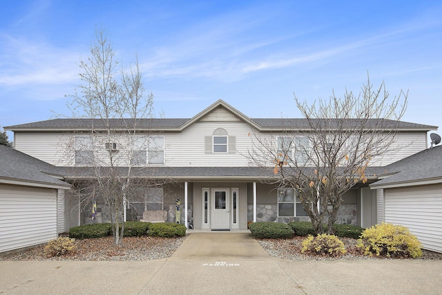 view of front of home featuring covered porch and stone siding