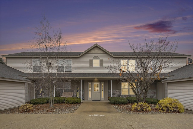 view of front of house with stone siding and a porch