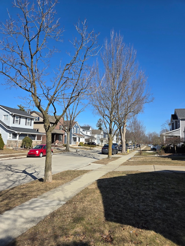 view of road with curbs, sidewalks, and a residential view