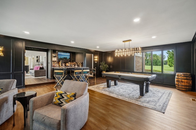 playroom with a decorative wall, light wood-style flooring, crown molding, and billiards