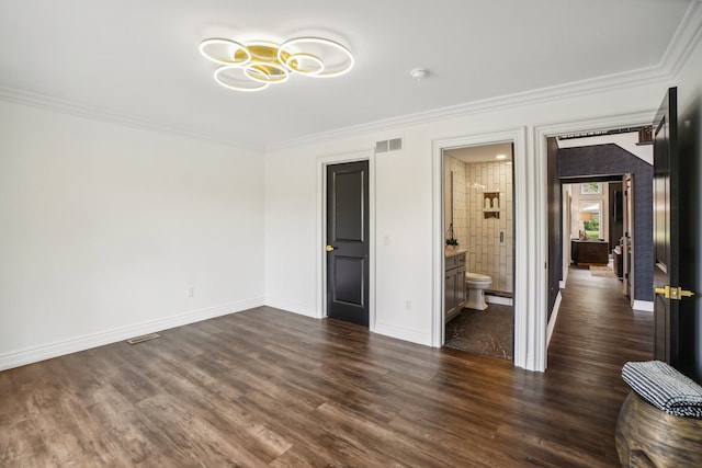 unfurnished bedroom with dark wood-type flooring, crown molding, visible vents, and baseboards