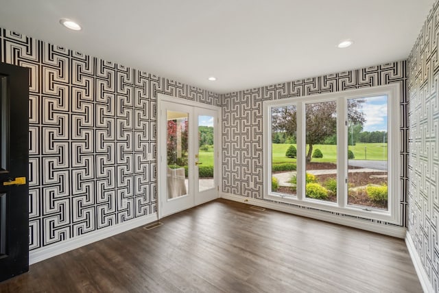 spare room with recessed lighting, wallpapered walls, dark wood-type flooring, and baseboards