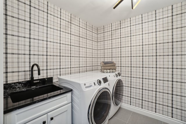 laundry room with independent washer and dryer, a sink, cabinet space, wallpapered walls, and light tile patterned floors