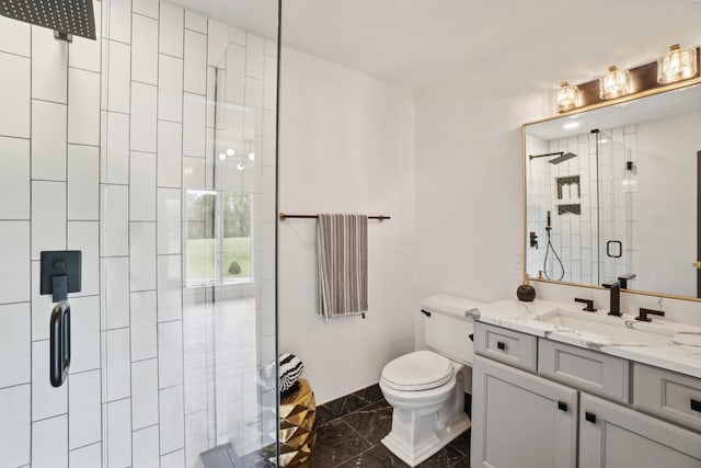 bathroom with a stall shower, toilet, and vanity