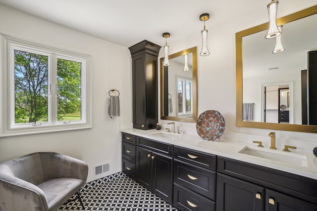 full bathroom with a sink, visible vents, and double vanity