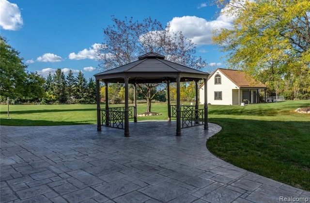 view of community featuring a gazebo, a patio, and a lawn