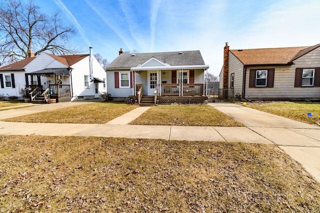 bungalow-style house with a porch and a front lawn