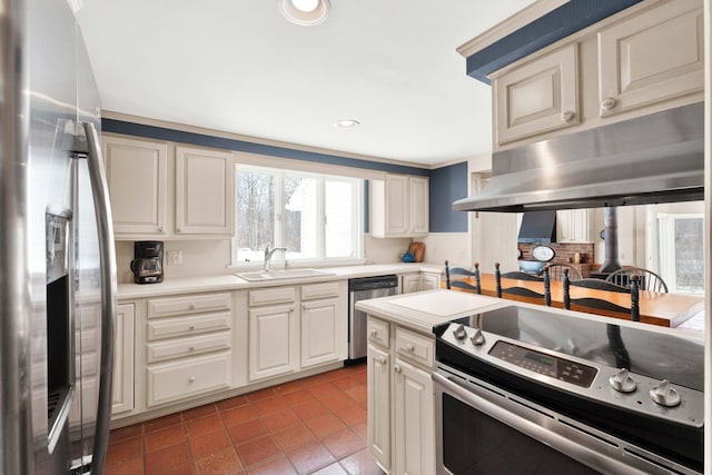 kitchen with a sink, under cabinet range hood, stainless steel appliances, light tile patterned flooring, and light countertops