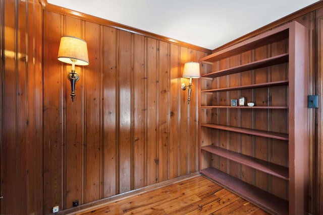 interior space featuring wood walls and hardwood / wood-style flooring