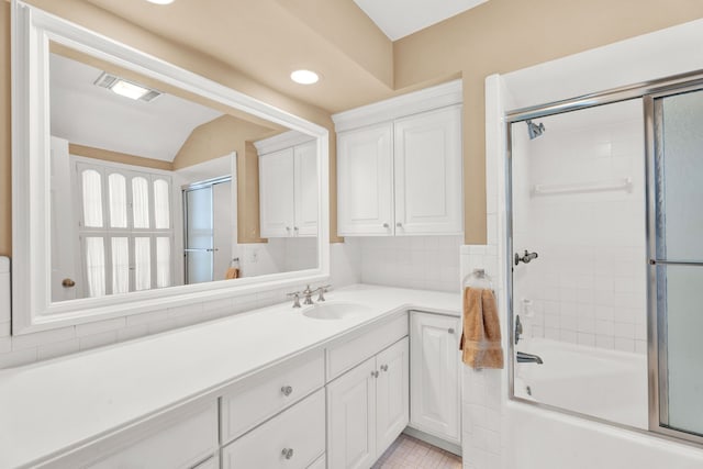 bathroom with tile patterned floors, visible vents, vanity, and bath / shower combo with glass door