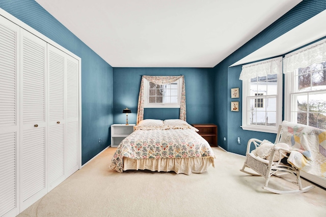 bedroom with vaulted ceiling, a closet, and carpet floors