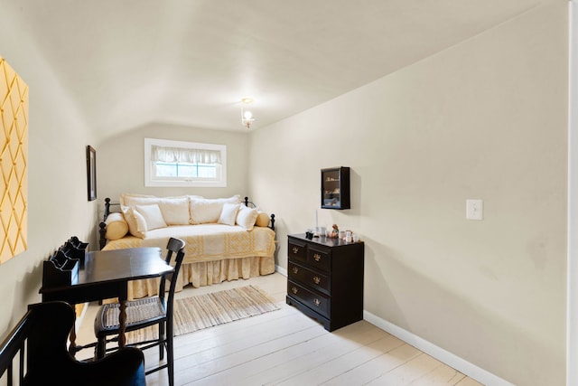 bedroom featuring light wood-style floors and baseboards