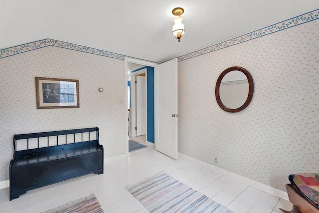 bedroom with tile patterned floors, baseboards, and wallpapered walls