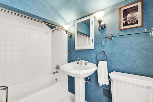 full bathroom featuring visible vents, a sink, bathtub / shower combination, vaulted ceiling, and toilet