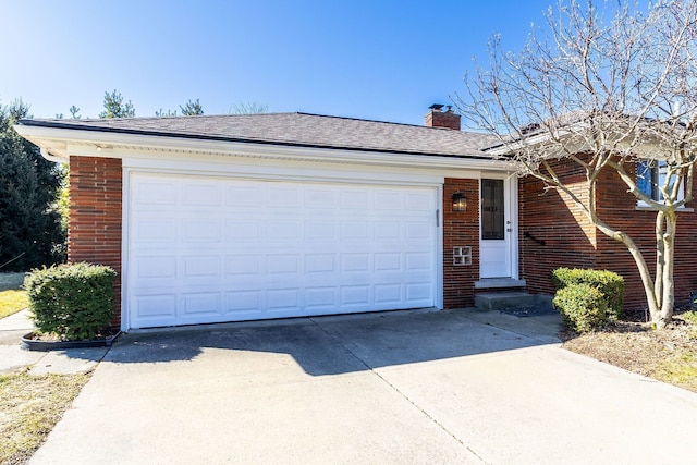 ranch-style house with brick siding, a chimney, concrete driveway, and an attached garage