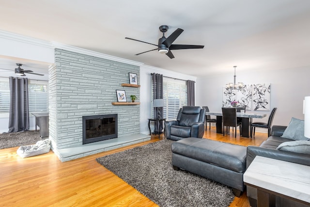 living room with a wealth of natural light, ceiling fan, and wood finished floors